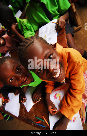 Kenya, Kakamega, schoolchildren drawing in classroom (MR). Stock Photo