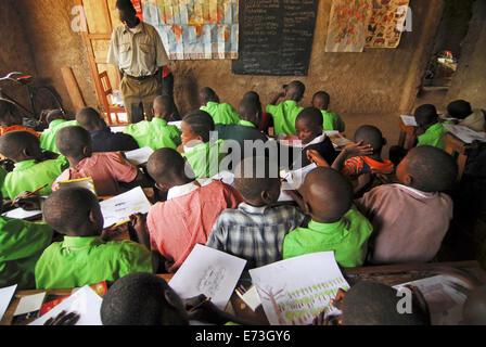 Kenya, Kakamega, schoolchildren drawing in classroom (MR). Stock Photo