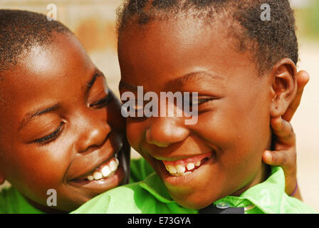 Kenya, Kakamega, portrait of boy and girl smiling together (MR). Stock Photo