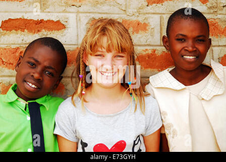 Kenya, Kakamega, black and white schoolgirls posing for camera (MR). Stock Photo