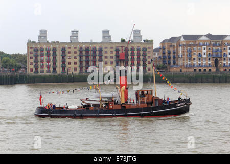 London, UK. 5th September, 2014.  The Portway Steam Tug passes Globe Wharf on the Thames at Rotherhithe. This is one of the boats attending the Tall Ships Festival 2014 which takes place in Woolwich, Maritime Greenwich, Greenwich Peninsula and Canary Wharf, from 5 to 9 Septembe. 50 Tall Ships will be attending the festival and will be moored for viewing at the various locations, as well as being sailed along the Thames. Credit:  Julia Gavin UK/Alamy Live News