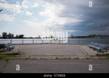 Storm clouds and trees blowing in the wind on a small bay at Whitby Lions Promenade. Whitby, Ontario, Canada. Stock Photo