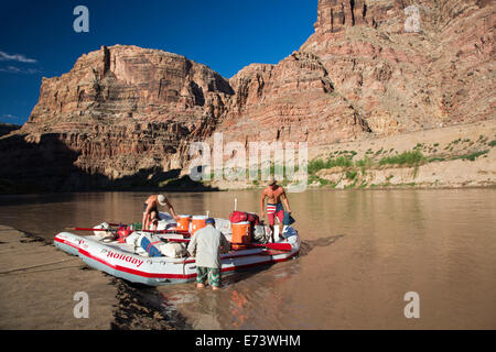Canyonlands National Park, Utah - Raft guides secure equipment and supplies in rafts before leaving an overnight campsite Stock Photo