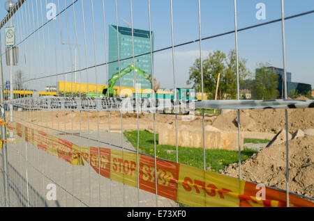 iron fence with red yellow security tape stop the construction site in the city Stock Photo
