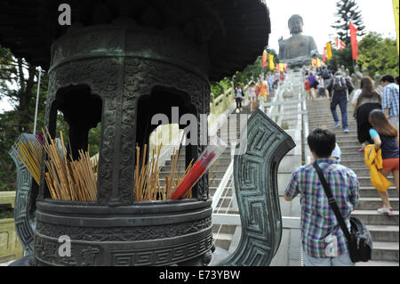 Incense sticks in urn, on stairs leading to the Tian Tan Buddha (Big Buddha) statue, Ngong Ping, Lantau Island, Hong Kong, China Stock Photo