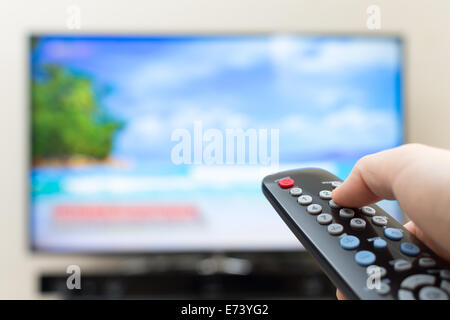 Program switching or button pressing on TV remote control Stock Photo