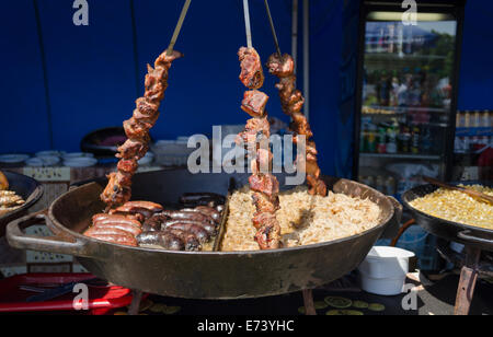 big bowl of rice sausage and three switches placed with shashlik on rural fair stall Stock Photo