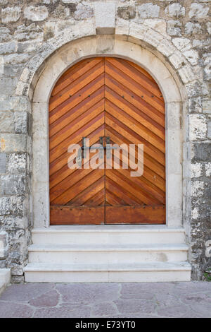 wooden door in stone wall Stock Photo