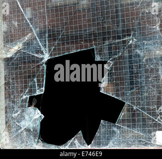 Broken window glass as a result of a burglary or break in. Stock Photo