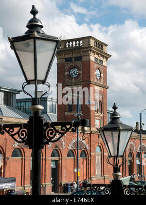 Clock tower of the indoor market hall and old-style street lamps, Ashton under Lyne, Tameside, Manchester, England, UK Stock Photo