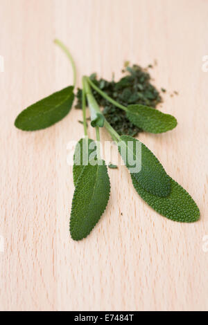 Salvia officinalis. Sage leaves on a wooden board. Stock Photo