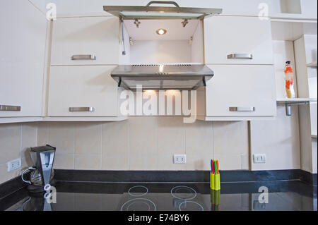 Closeup detail of kitchen area cooker top in luxury apartment show home Stock Photo