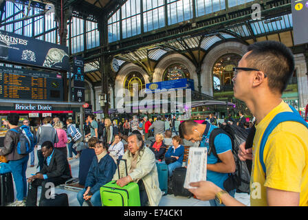 Paris, France, Europe Chinese Tourist, in Crowd, in Profile, Holding Train Ticket,  Waiting inside Hall Gare de Lyon Train Station, student France,  sncf ticket Stock Photo