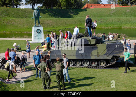 Copenhagen, Denmark. 6th September, 2014. Open House in celebration of the 400th anniversary of the Danish army.  A great number of present and former service personnel, veterans, families, curious Danes and tourists visit the comprehensive hands-on exhibitions, performances, and activities at  Kastellet (the Citadel) and the neighbouring Churchill Park. Getting close to, climbing into, touch, and ask questions about vintage and contemporary combat and special  vehicles was a hit. In this case a contemporary combat vehicle of the type CV-9035. Credit:  Niels Quist/Alamy Live News Stock Photo