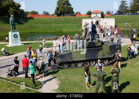 Copenhagen, Denmark. 6th September, 2014. Open House in celebration of the 400th anniversary of the Danish army.  A great number of present and former service personnel, veterans, families, curious Danes and tourists visit the comprehensive hands-on exhibitions, performances, and activities at  Kastellet (the Citadel) and the neighbouring Churchill Park. Getting close to, climbing into, touch, and ask questions about vintage and contemporary combat and special  vehicles was a hit. In this case a combat vehicle of the type CV-90. Credit:  Niels Quist/Alamy Live News Stock Photo