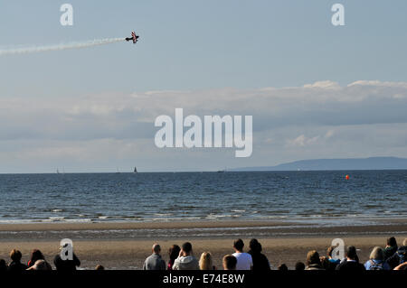 Ayr, Scotland, UK. 6th September 2014. Aircraft take part in a display in the skies above Ayr for the first time in 22 years. The free air display had various flying acts including the famous blades aerobatic display team who are all ex-Red Arrow Pilots. Pitts Special smoke trail flypast with a smoke trail over beach. Credit:  Andrew Steven Graham/Alamy Live News Stock Photo