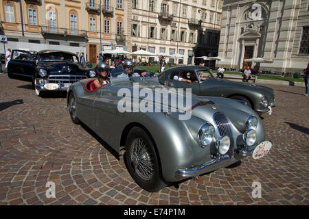 Torino, Italy. 6th September 2014. Vintage cars arriving in Piazza Carlo Alberto. In the foreground a Jaguar XK120 OTS. Collectors of historical cars met in Torino for a car elegance competition. Stock Photo