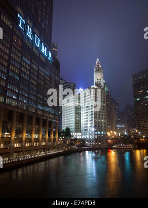 A view of the Wrigley Building, Trump International Hotel and Tower Chicago, and the Chicago River at night.  Chicago, Illinois. Stock Photo