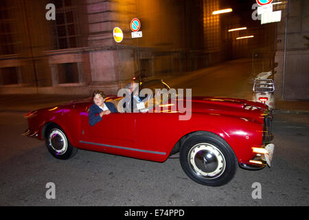 Torino, Italy. 6th September 2014. A car collector drives his Lancia Aurelia during a night ride. Collectors of historical cars met in Torino for a car elegance competition. Stock Photo