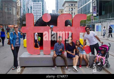 Toronto, Canada. 6th Sep, 2014. Visitors pose for photos with the symbol of the Toronto International Film Festival at the pedestrian mall of the 39th Toronto International Film Festival in Toronto, Canada, on Sept. 6, 2014. Credit:  Zou Zheng/Xinhua/Alamy Live News Stock Photo