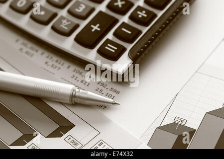 Financial statements. Business Graph. Ballpoint pen and calculator on a financial chart or Stock Market Data. Stock Photo