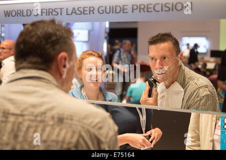 Berlin, Germany. 07th Sep, 2014. A visitor tests an electric razor at the Philips trade fair stand on the third day of the electronics trade fair IFA in Berlin, Germany, 07 September 2014. IFA takes place from 5 September - 10 September in Berlin. PHOTO: JOERG CARSTENSEN/DPA/Alamy Live News Stock Photo