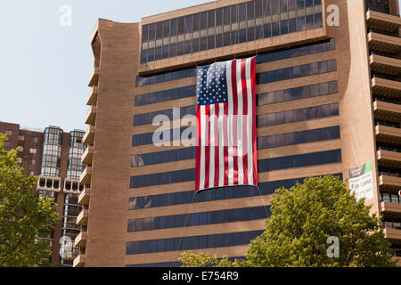 American flag hanging from high-rise office building - Arlington, Virginia USA Stock Photo