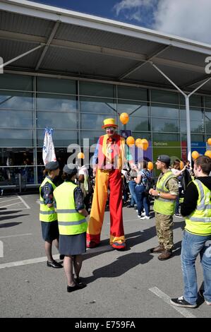 Gorton, Manchester, UK. 7th Sep, 2014. Gorton Carnival Parade on way to Debdale Park, with a stop on Tesco car park, Gorton, for several of the groups in the parade to perform for spectators.-'Smilie' on stilts with Air Training Cadets Stock Photo