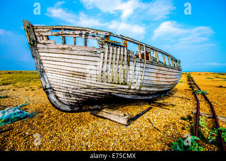 The abandoned fishing boats and railway tracks on the beach at Dungeness, East Sussex Stock Photo