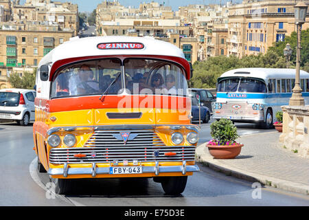 Coach driver & group of people on bus sightseeing tour passengers travelling in old restored colourful Maltese AEC buses in Valletta Malta EU Stock Photo