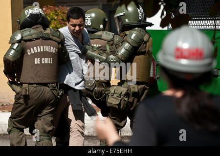 Santiago, Chile. 7th Sep, 2014. Riot police arrest a demonstrator during a clashes on the 41st anniversary of the military coup that brought Augusto Pinochet to power, in Santiago, capital of Chile, on Sept. 7, 2014. By the end of Pinochet's regime in 1990, 200,000 Chileans were driven into exile, 40,000 were tortured by the security apparatus, and more than 3,000 were executed or remain unaccounted for in the country. Credit:  Jorge Villegas/Xinhua/Alamy Live News Stock Photo