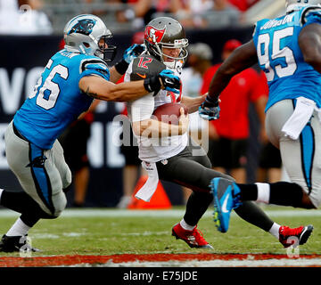 St Persburg, Florida, USA. 7th September, 2014. Tampa Bay Buccaneers quarterback Josh McCown (12) gets away from Carolina Panthers inside linebacker A.J. Klein (56) as he scrambles up the middle for 11 yards during third quarter action at Raymond James Stadium in Tampa on Sunday (09/07/14) © ZUMA Press, Inc/Alamy Live News Stock Photo