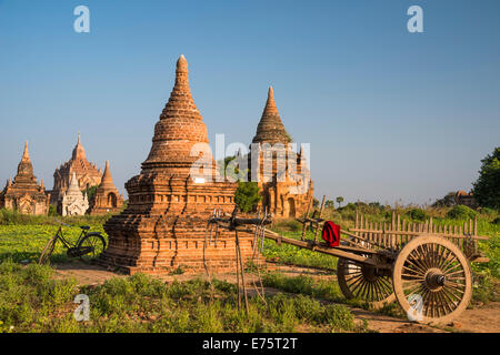 Cart and a bicycle in front of pagoda, temples, stupas in the temple complex of the Plateau of Bagan, Mandalay Division Stock Photo