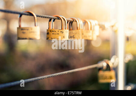 Padlocks as love locks hanging next to each other on a bridge railing, Grevenbroich, North Rhine-Westphalia, Germany Stock Photo