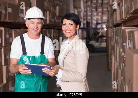 Warehouse worker and manager using tablet pc Stock Photo