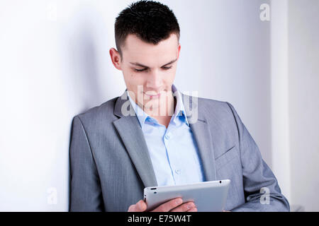 Young man holding a tablet computer Stock Photo