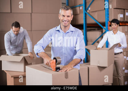 Warehouse workers packing up boxes Stock Photo