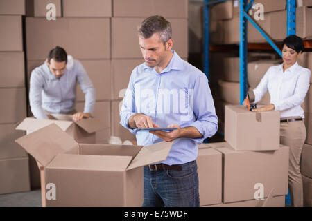 Warehouse workers packing up boxes Stock Photo