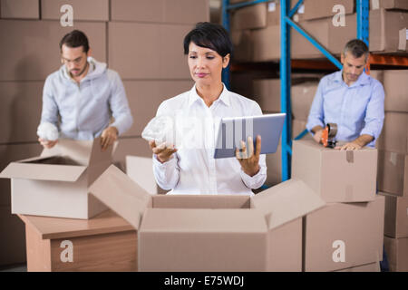 Warehouse workers packing up boxes Stock Photo