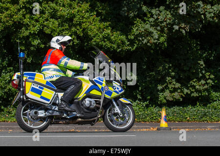 Merseyside Police motorcyclist outrider in Liverpool, Merseyside, UK 7th September, 2014. Policing the first Sky Ride Liverpool and Tour of Britain.  Cyclists were given the chance to ride an elite route then watch the pros race it during Stage One of the Tour of Britain. This combined with athlete appearances, celebrity guests and a huge range of fun activities to try. Stock Photo