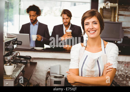 Pretty barista smiling at camera Stock Photo