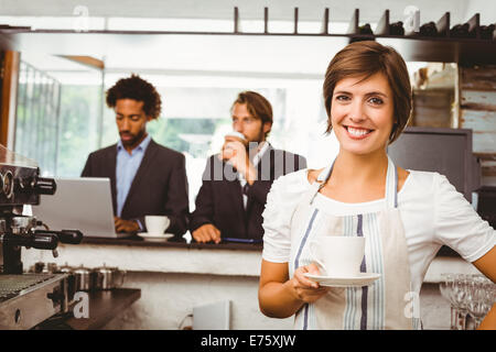 Pretty barista smiling at camera Stock Photo