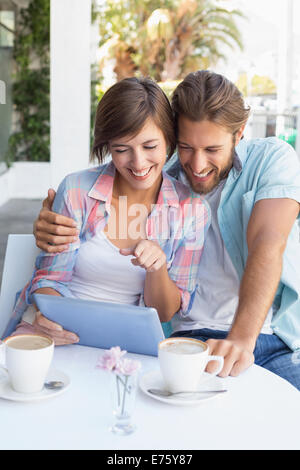Happy couple on a date using tablet pc Stock Photo