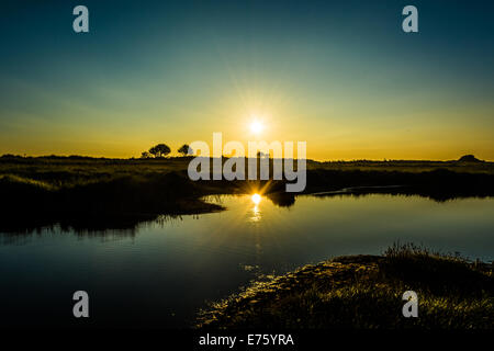 Sunrise reflected in water Stock Photo