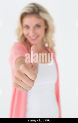 Happy young woman gesturing thumbs up Stock Photo