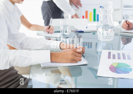 Business woman writing down notes Stock Photo