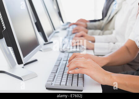 Employees typing on their computers Stock Photo