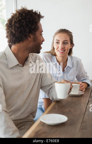 Happy couple on a date having coffee Stock Photo