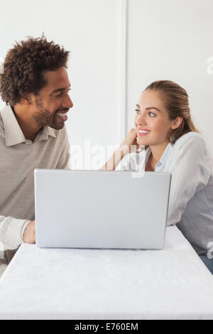 Happy couple on a date using laptop Stock Photo