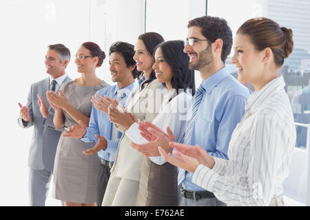 Applauding workers smiling and cheerful Stock Photo